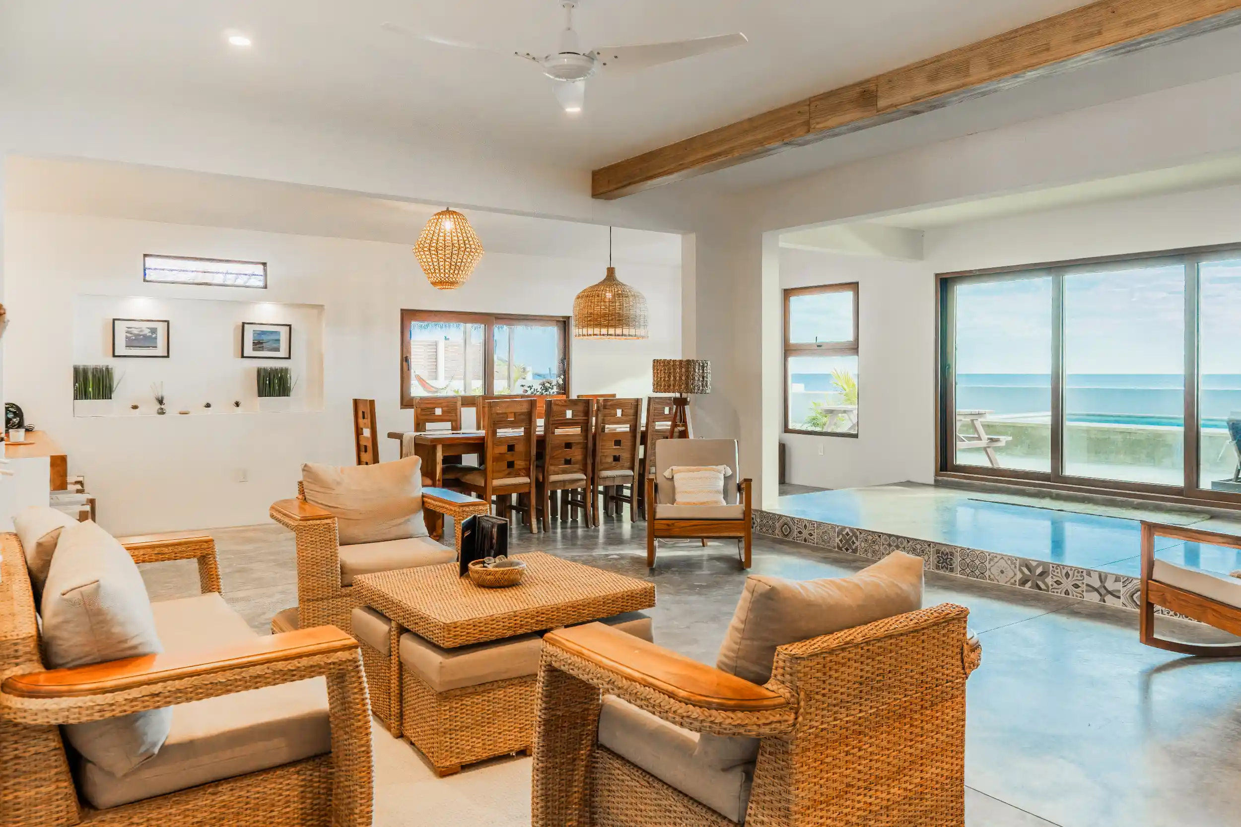 Warm, open-concept interior featuring natural materials, custom wood furnishings, and seamless indoor-outdoor living