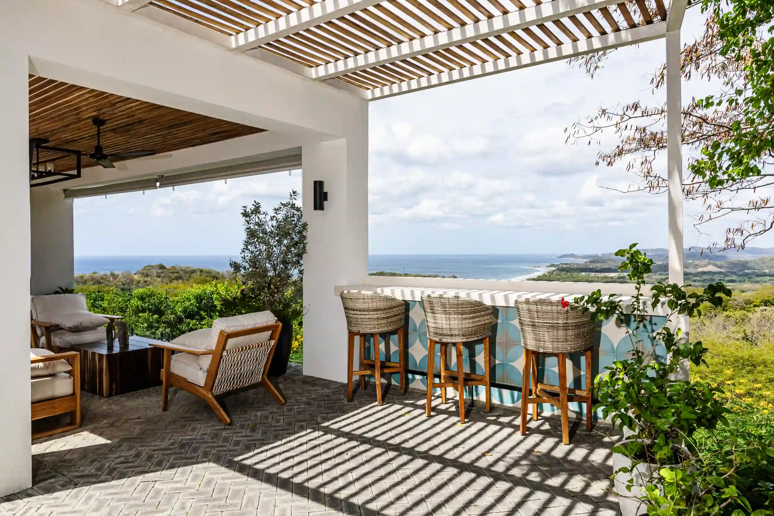 Covered outdoor living area showcasing quality construction and development, with custom finishes, open-air design, and panoramic