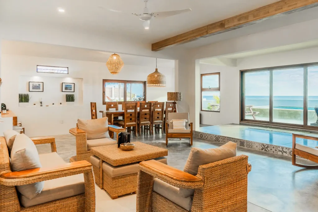 Warm, open-concept interior featuring natural materials, custom wood furnishings, and seamless indoor-outdoor living
